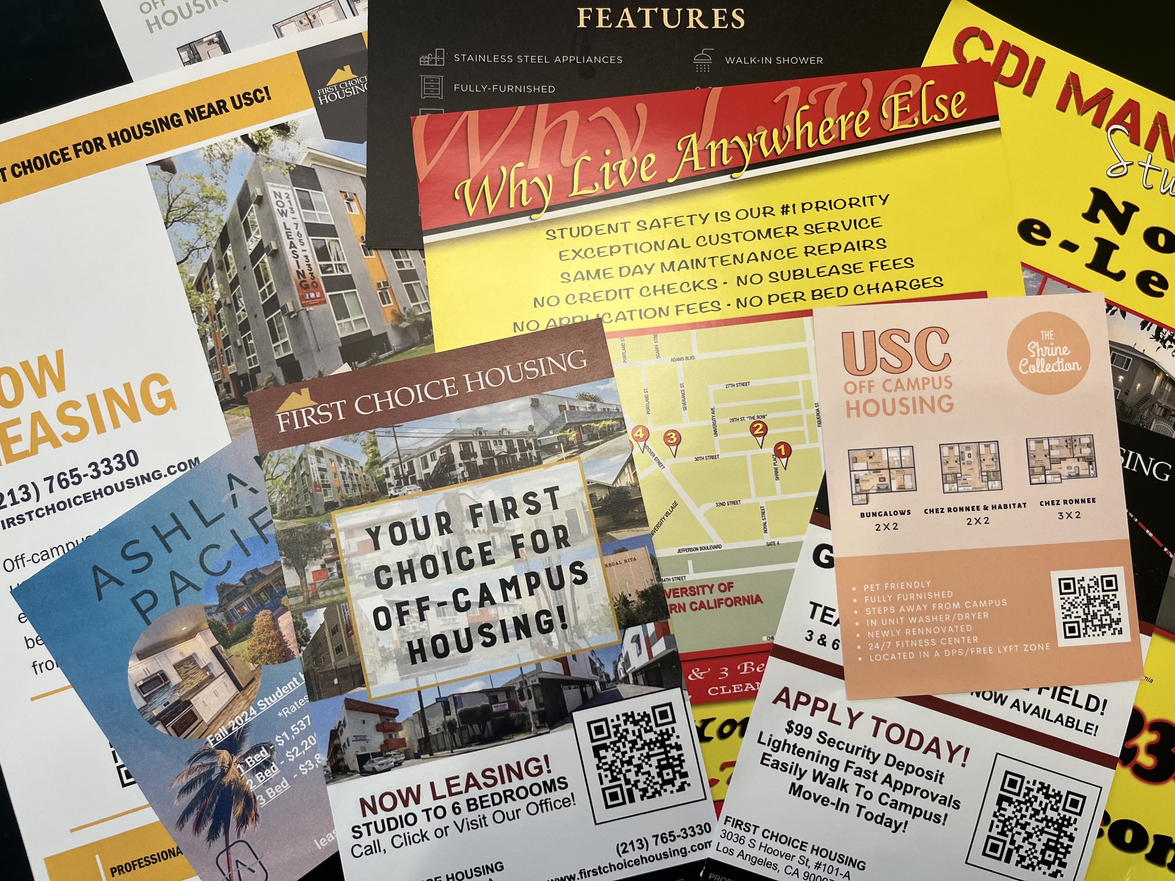 A photo of different promotional materials for off-campus housing apartments in the USC neighborhood.
