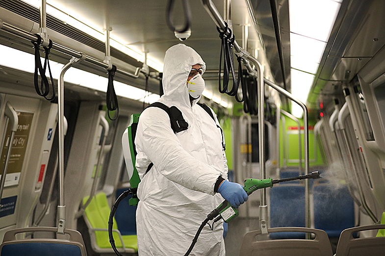 Man disinfects train.
